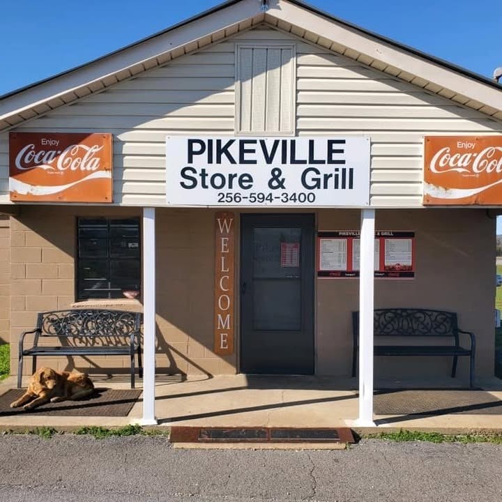 Pikeville Store and Grill storefront with American flags and Coca-Cola signs
