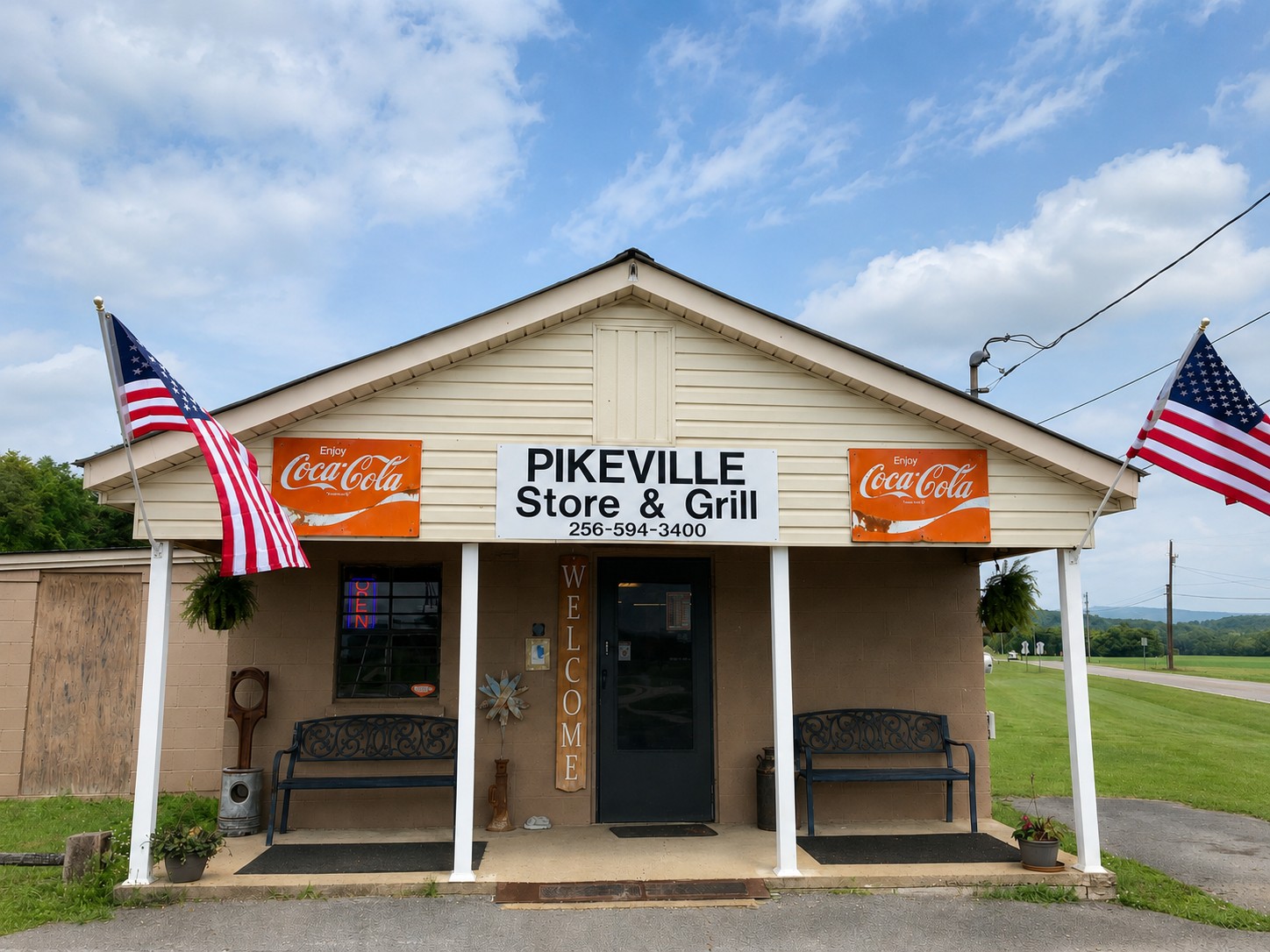 The full storefront of Pikeville Store and Grill with American flags and Coca-Cola signs
